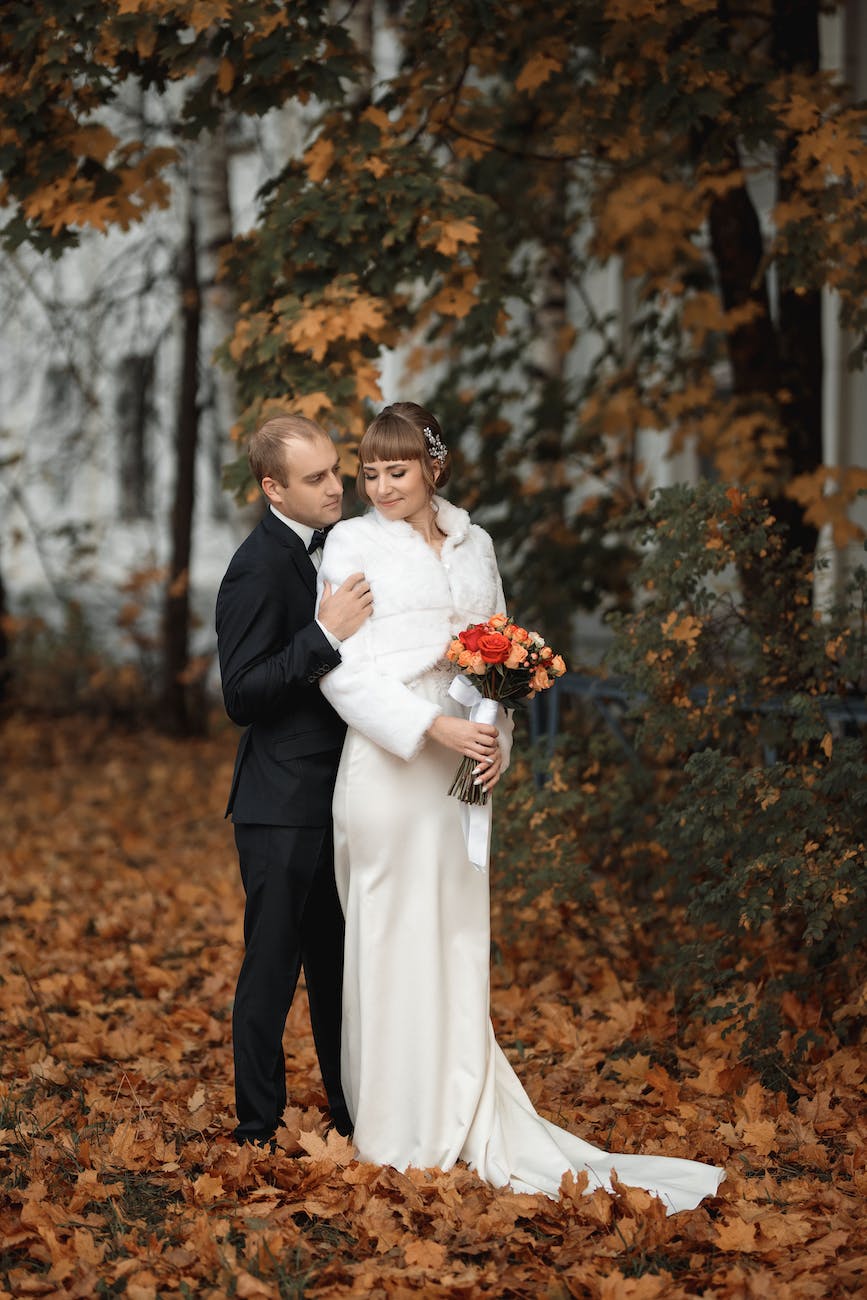 bride and groom posing in an autumnal forest