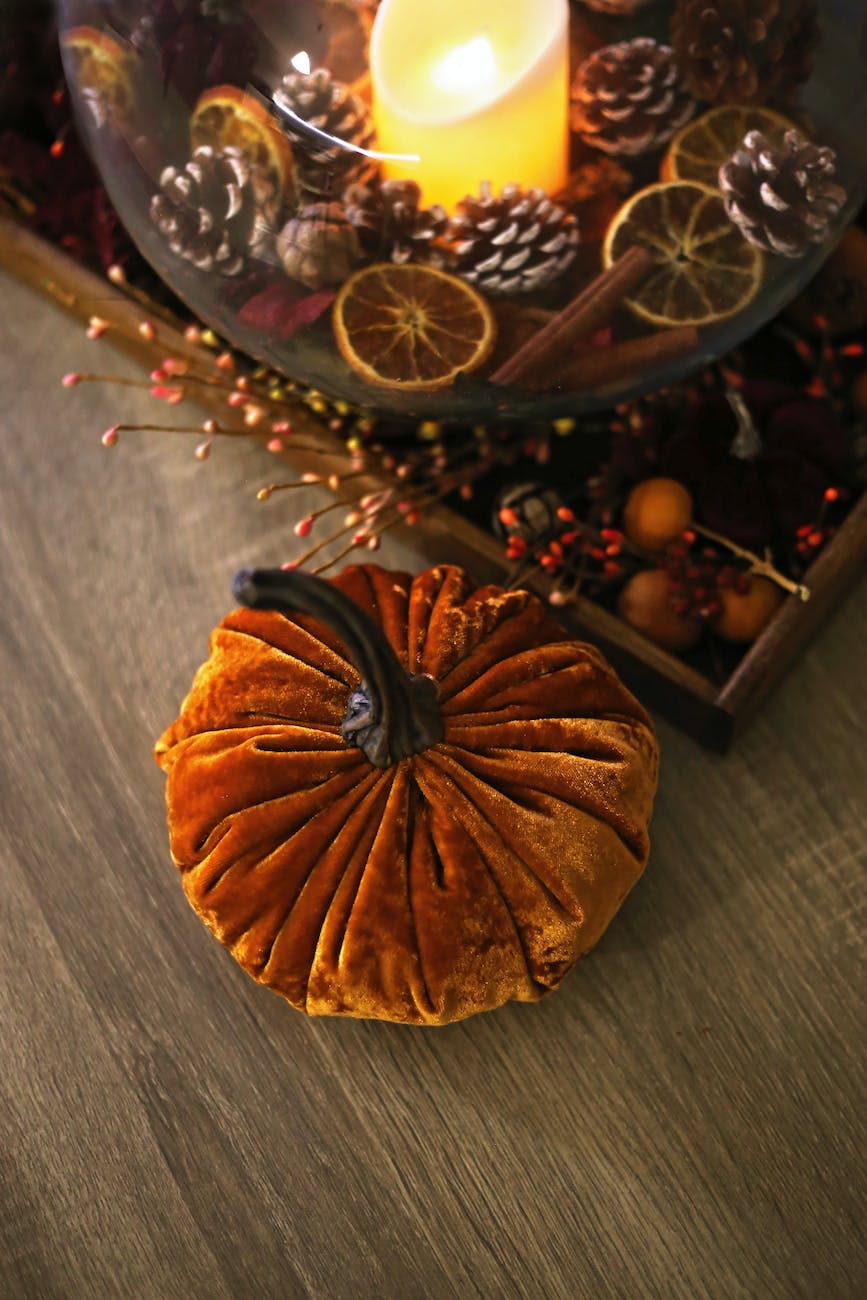 pine cones and dried orange slices around a lighted candle